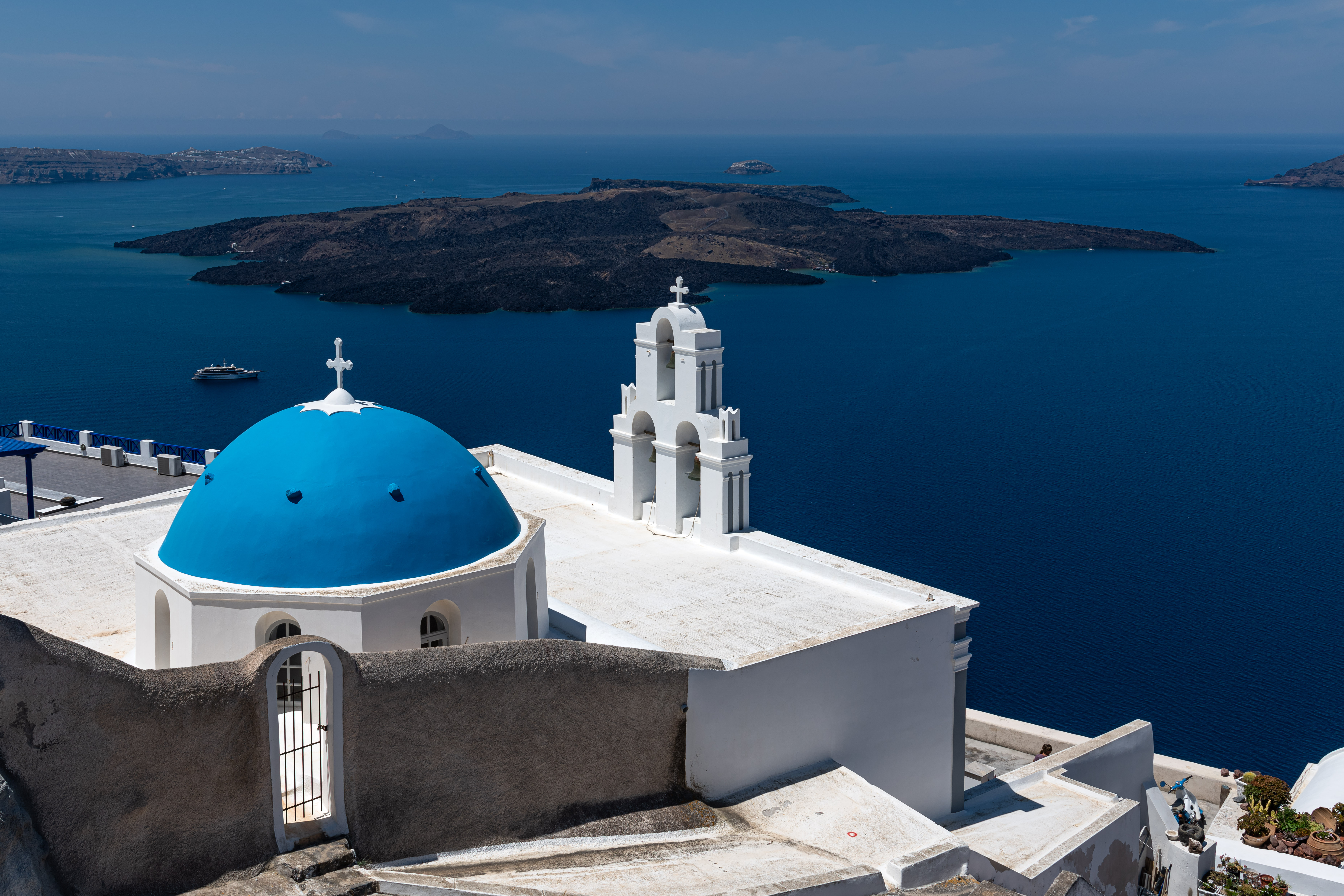 Blue-domed church and white buildings in Fira, Santorini